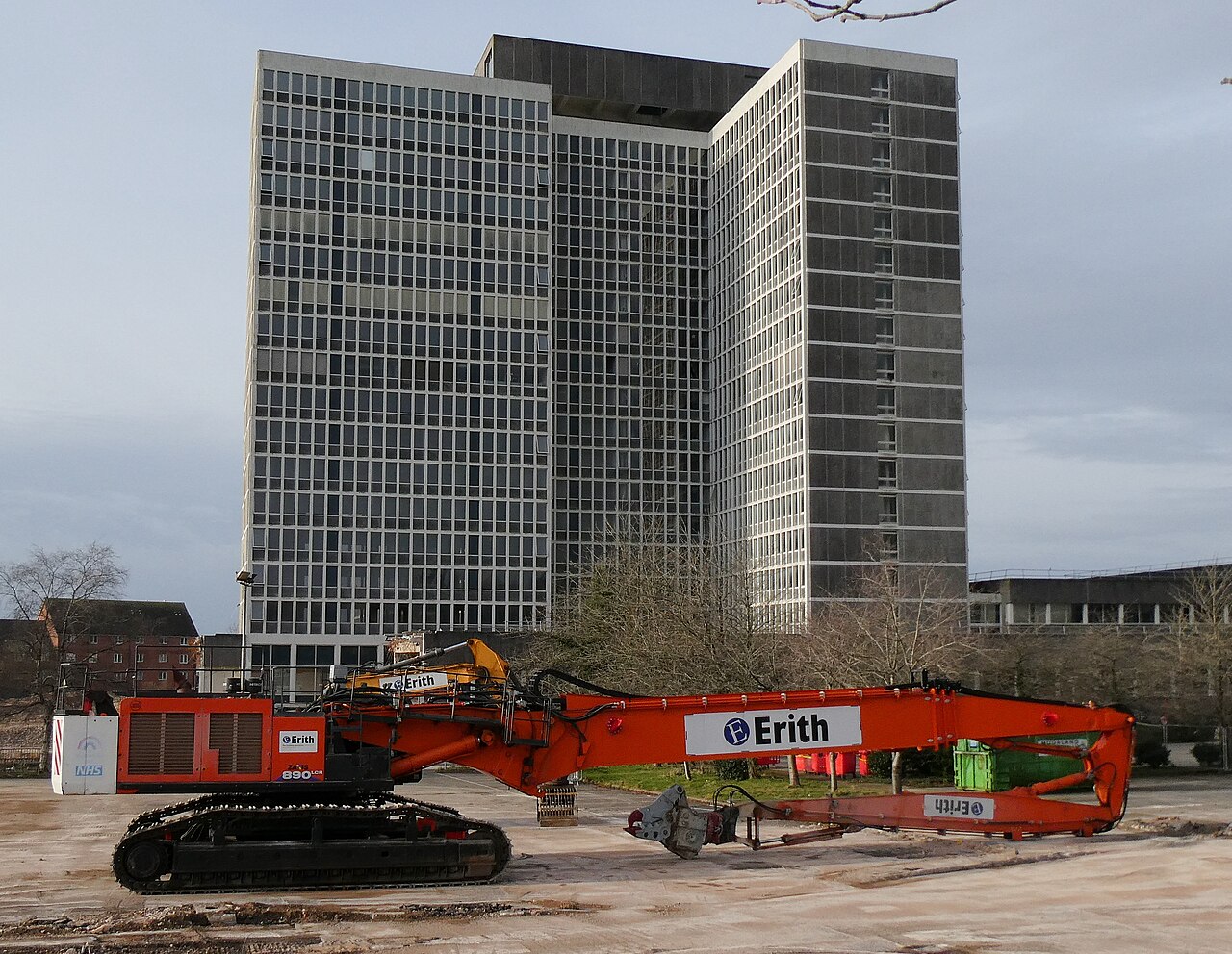 High-reach excavator at commercial demolition site