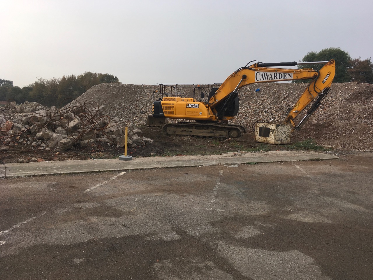 Digger clearing rubble and debris